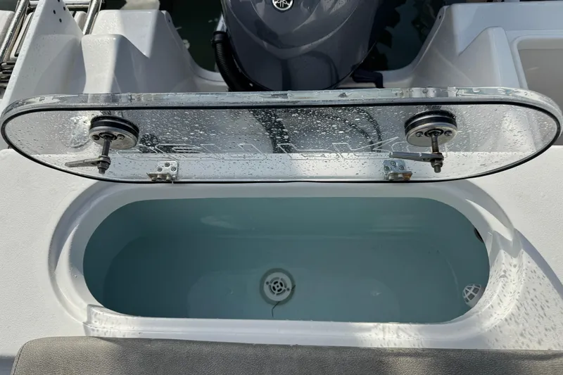 Slide: The Image of Livewell on 2023 Sea Pro 239 Deep V CC boat, open lid with water inside. - 34