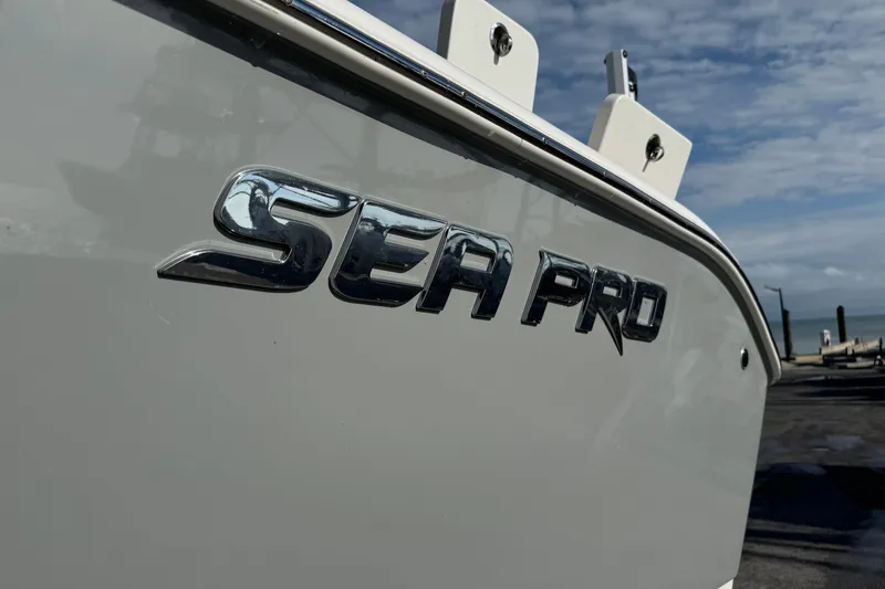 Slide: The Image of 2023 Sea Pro 239 Deep V CC boat with logo, dockside view. - 37