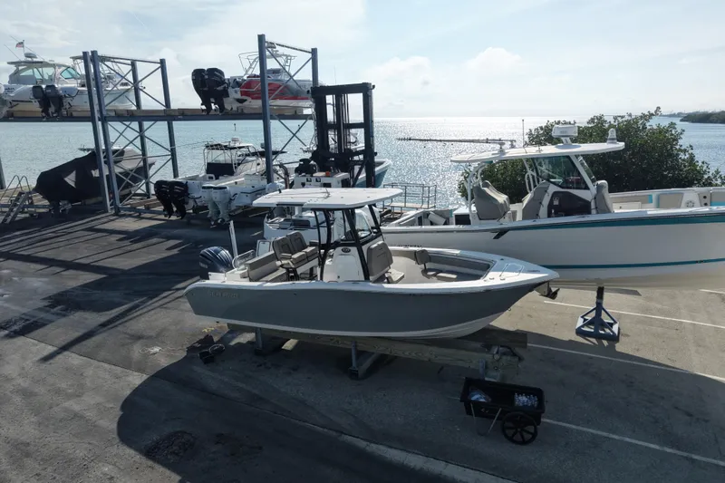 Slide: The Image of 2023 Sea Pro 239 Deep V CC boat docked at marina with ocean view. - 40