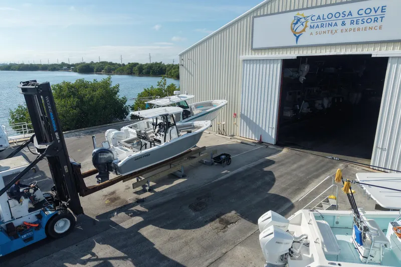 Slide: The Image of 2023 Sea Pro 239 Deep V CC boat at Caloosa Cove Marina, near water and greenery. - 41