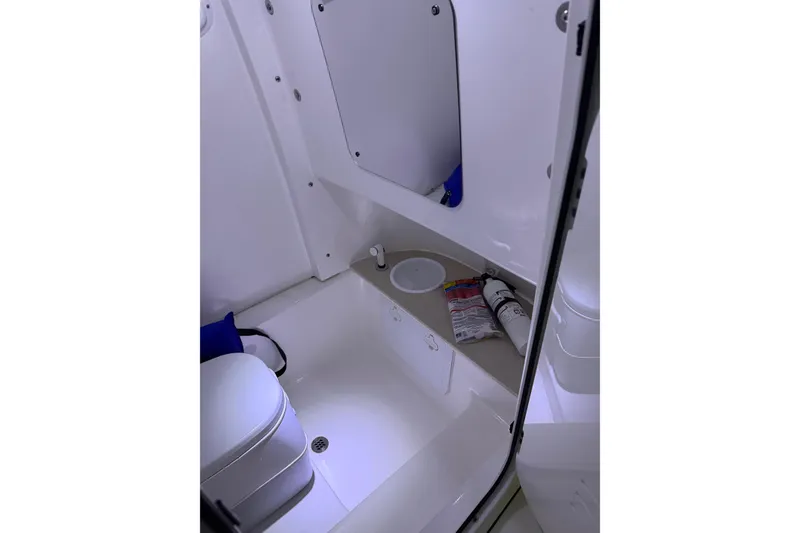 Slide: The Image of 2023 Sea Pro 239 Deep V CC boat interior with toilet and storage area. - 44