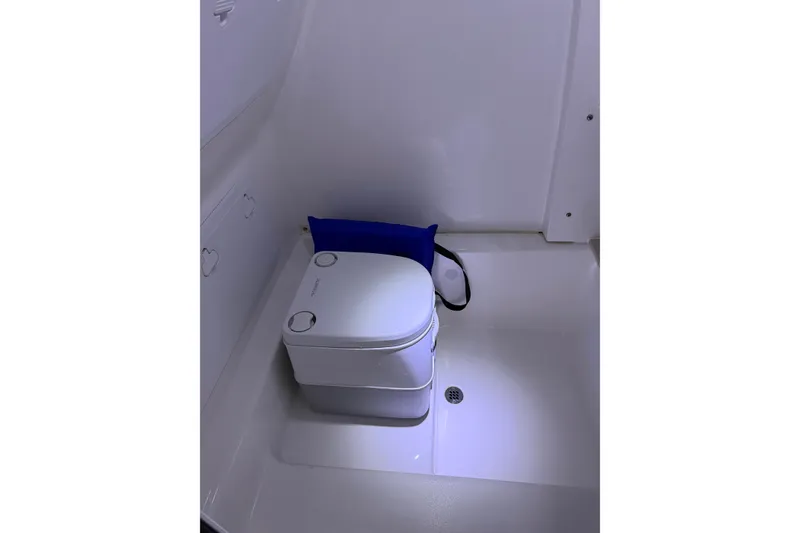 Slide: The Image of 2023 Sea Pro 239 Deep V CC boat interior with compact marine toilet. - 45