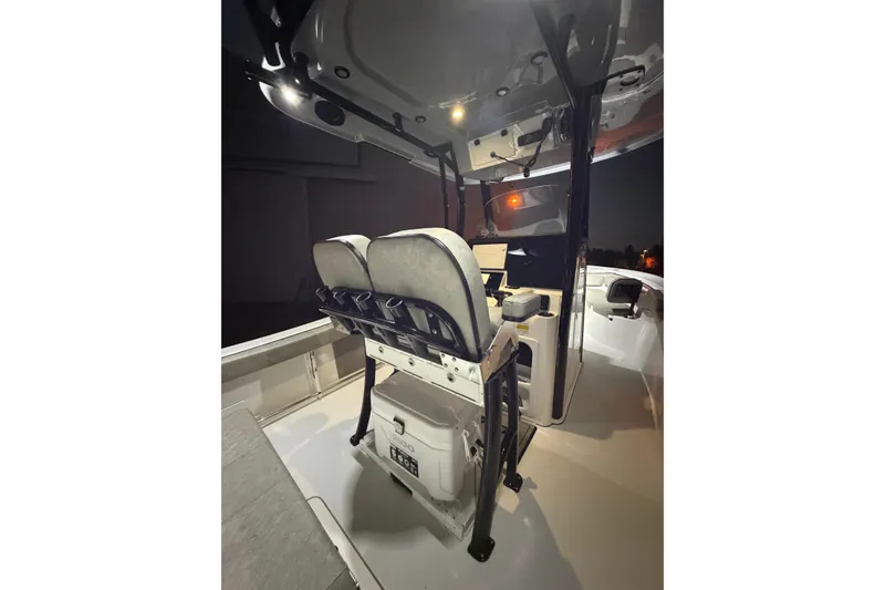 Slide: The Image of 2023 Sea Pro 239 Deep V CC boat interior with dual seats and console at night. - 46