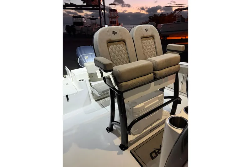 Slide: The Image of 2023 Sea Pro 239 Deep V CC boat seats at sunset, featuring cushioned armrests. - 47