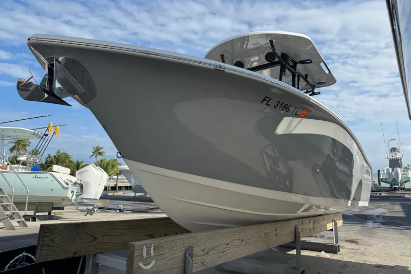 Slide: The Image of 2023 Sea Pro 239 Deep V CC boat on display, docked under a clear sky. - 5