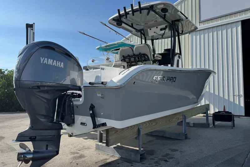 Slide: The Image of 2023 Sea Pro 239 Deep V CC boat with Yamaha engine, docked near a white building. - 7