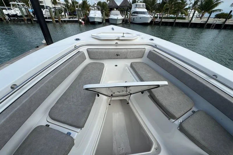 Slide: The Image of 2023 Sea Pro 239 Deep V CC boat interior with open storage compartment, docked near yachts. - 8