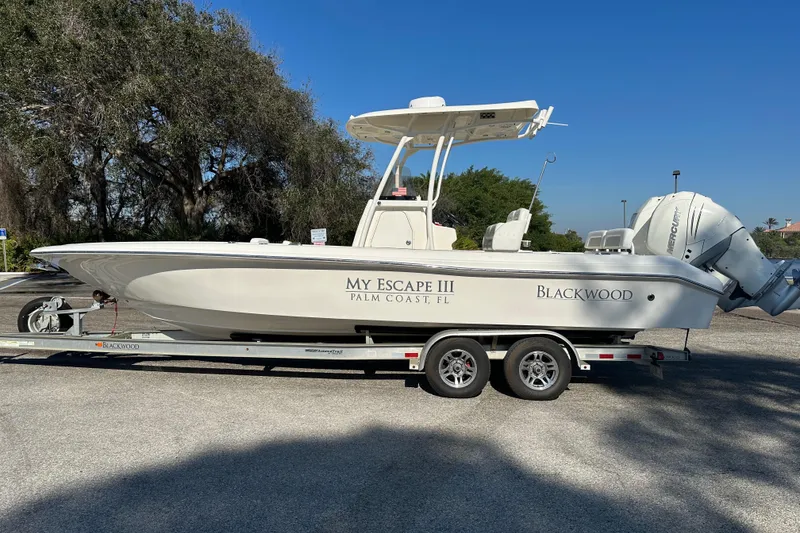 The Image of 2018 Blackwood 27 Bayboat on trailer under blue sky at Afy's Tampa. - 0