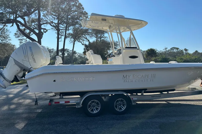 Slide: The Image of 2018 Blackwood 27 Bayboat on trailer under blue sky. - 1