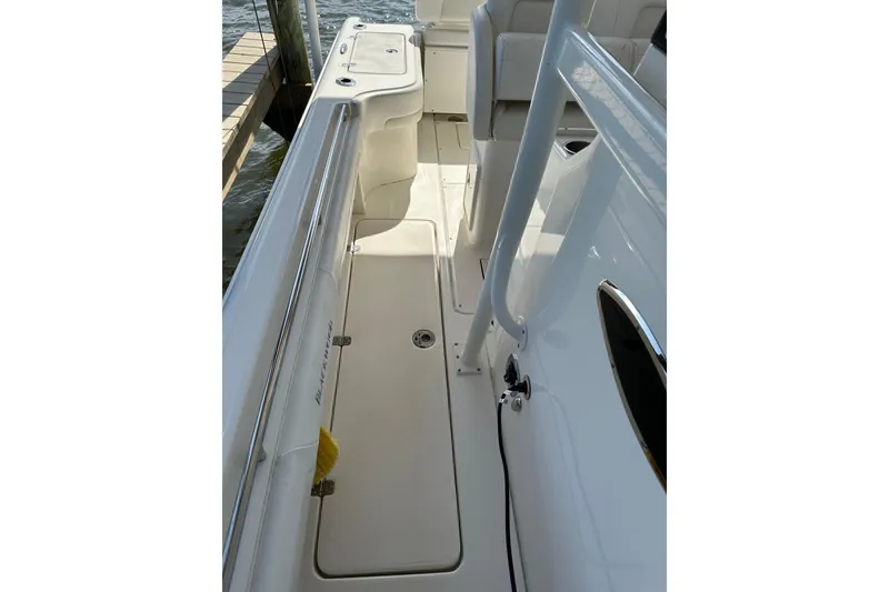Slide: The Image of 2018 Blackwood 27 Bayboat cockpit with steering wheel, navigation screens, and rod holders. - 13