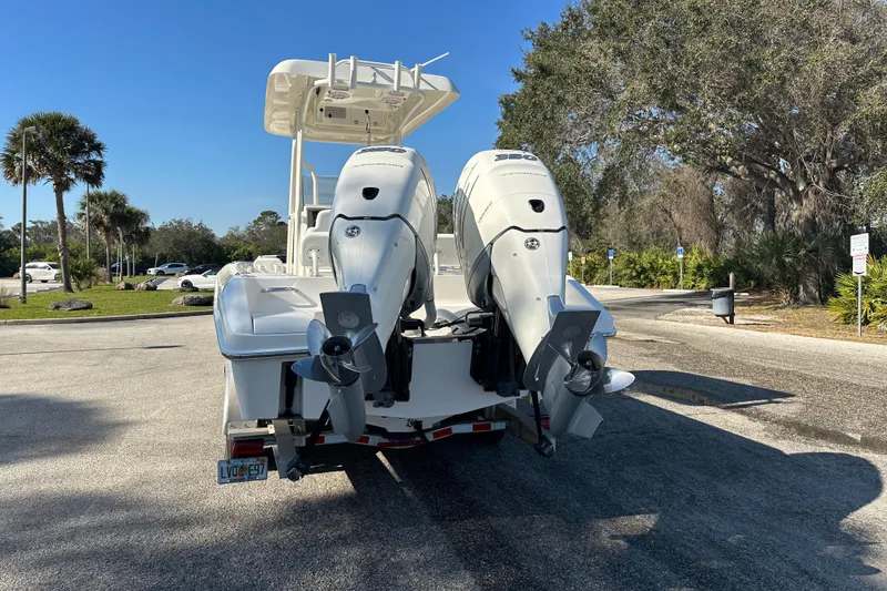Slide: The Image of 2018 Blackwood 27 Bayboat with Mercury Verado engine on trailer under blue sky. - 2