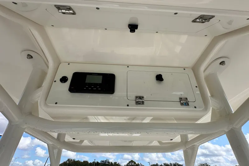 Slide: The Image of 2018 Blackwood 27 Bayboat joystick control and cup holder on textured dashboard. - 31