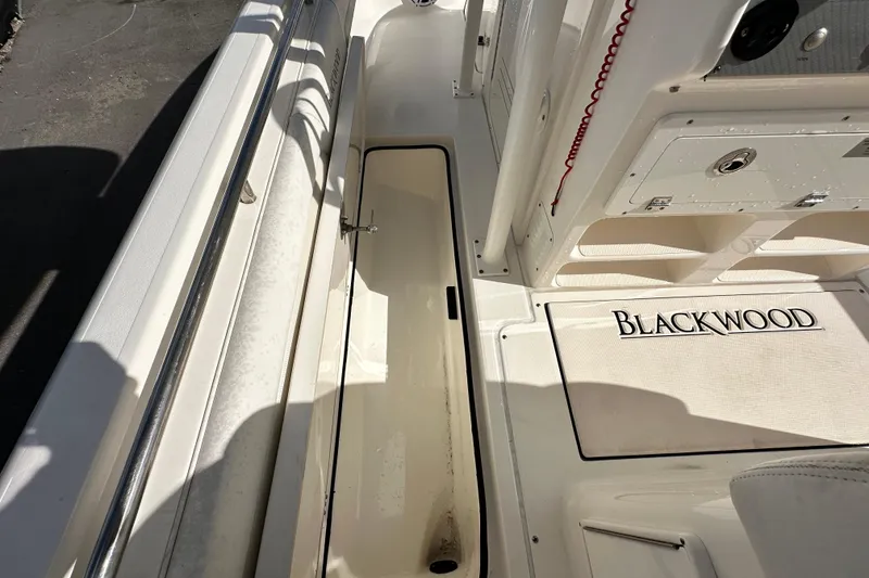 Slide: The Image of 2018 Blackwood 27 Bayboat console with Garmin device and open storage compartment. - 36
