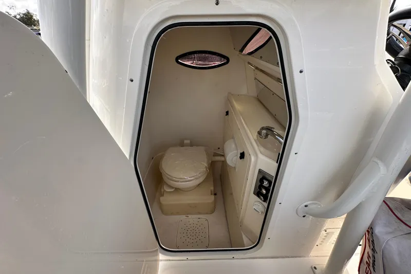 Slide: The Image of 2018 Blackwood 27 Bayboat interior with storage compartment and branded mat. - 40