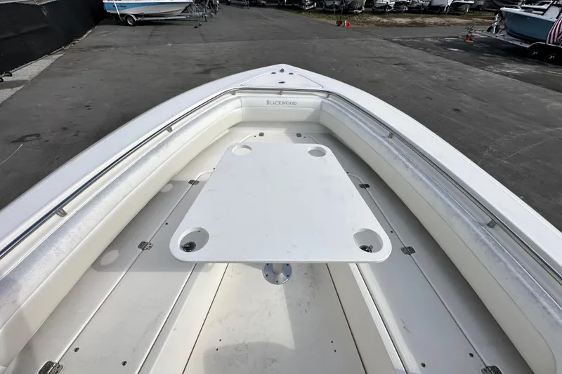 Slide: The Image of 2018 Blackwood 27 Bayboat interior with JL Audio speaker and seating under blue sky. - 49