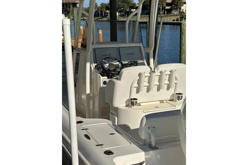 Slide: The Image of 2018 Blackwood 27 Bayboat with Mercury Verado engine, parked outdoors under a cloudy sky. - 5