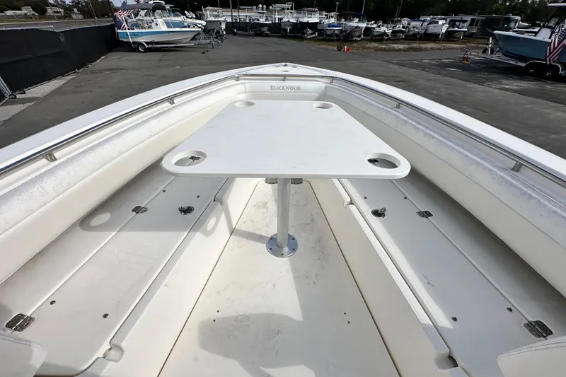 Slide: The Image of 2018 Blackwood 27 Bayboat on display at a marina under a partly cloudy sky. - 50