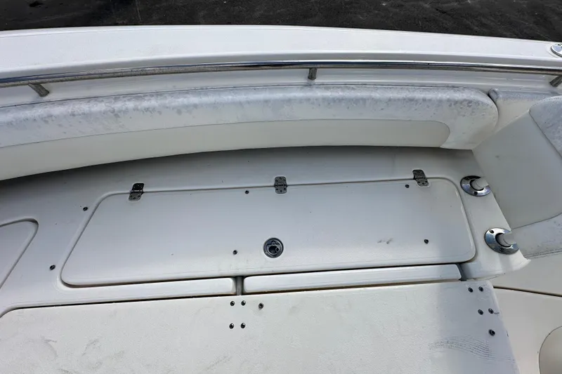 Slide: The Image of 2018 Blackwood 27 Bayboat interior with seating and speakers, docked on pavement. - 51