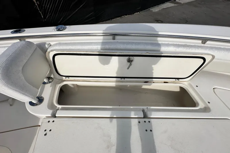 Slide: The Image of 2018 Blackwood 27 Bayboat interior with cushioned seating and storage compartments. - 53