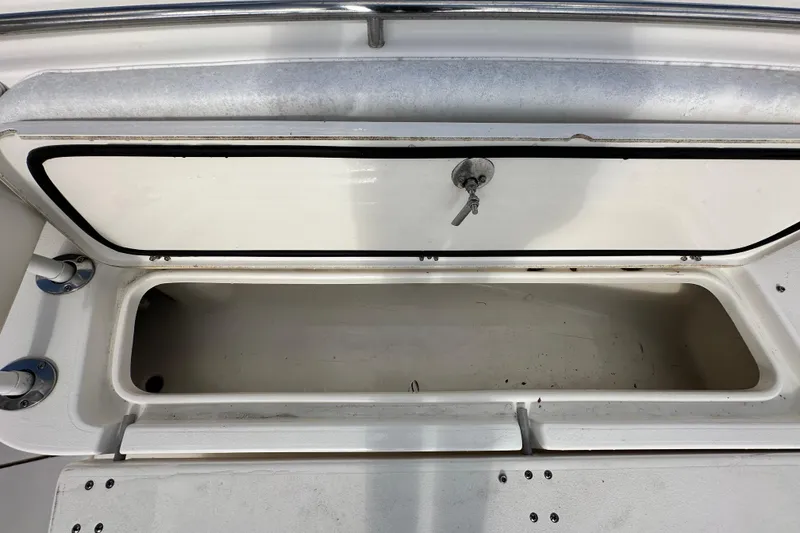 Slide: The Image of 2018 Blackwood 27 Bayboat interior with seating and speakers, docked at a marina. - 54