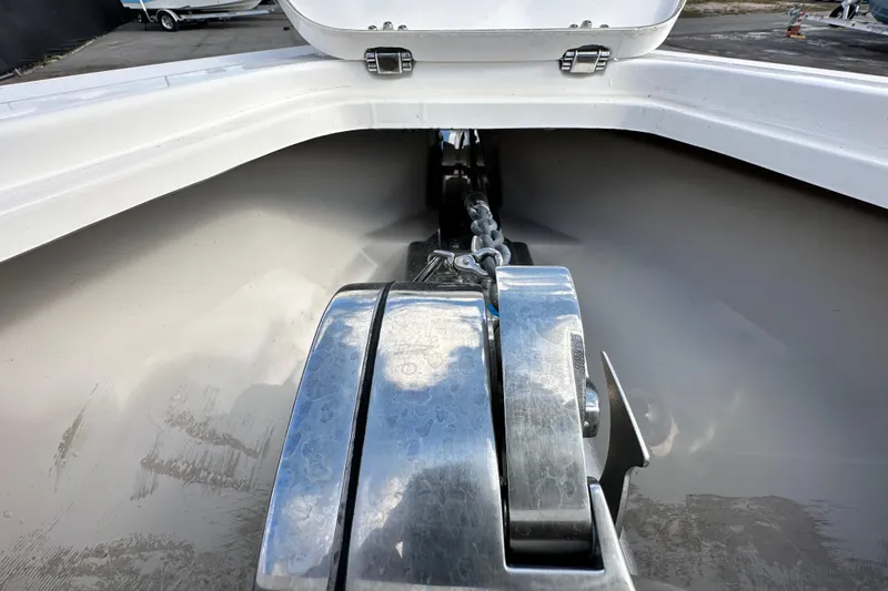 Slide: The Image of 2018 Blackwood 27 Bayboat with table, docked under a partly cloudy sky. - 59