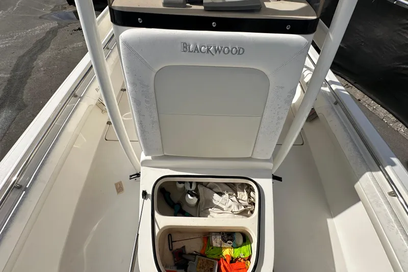 Slide: The Image of 2018 Blackwood 27 Bayboat interior with storage compartments and seating. - 65