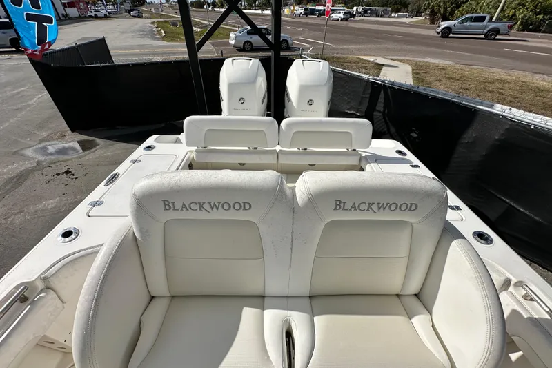 Slide: The Image of 2018 Blackwood 27 Bayboat with white seating and storage compartment on deck. - 70