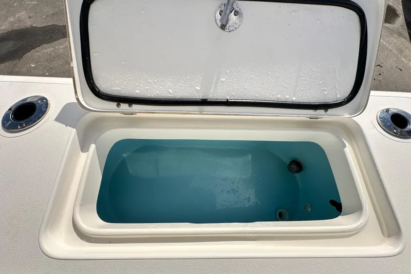 Slide: The Image of Open livewell on 2018 Blackwood 27 Bayboat, filled with water, showcasing fishing utility. - 86