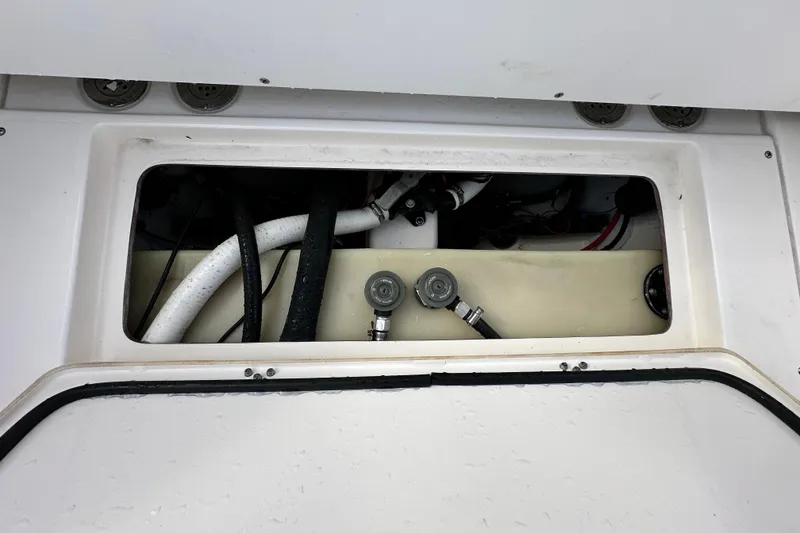Slide: The Image of 2018 Blackwood 27 Bayboat interior compartment with hoses and fittings. - 87