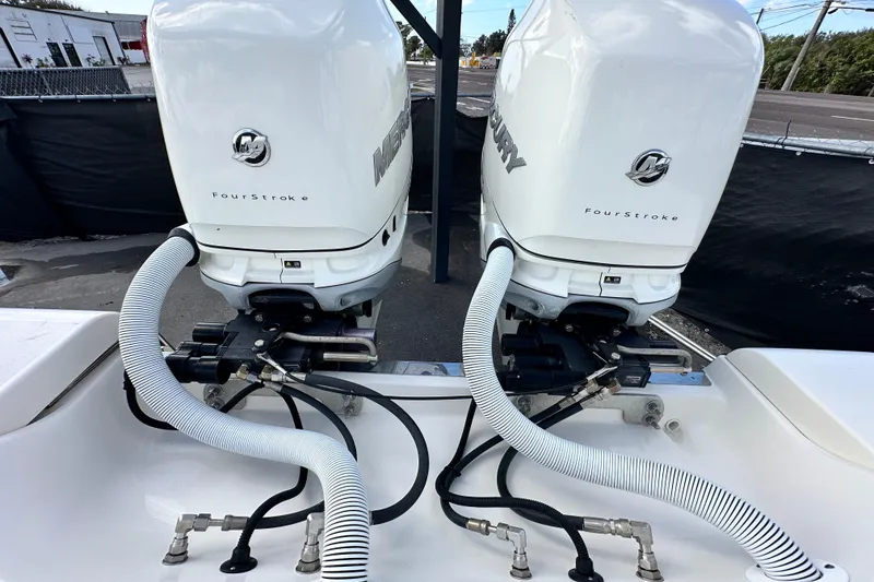 Slide: The Image of Twin Mercury FourStroke engines on a 2018 Blackwood 27 Bayboat. - 88