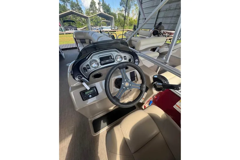 Slide: The Image of 2023 Sun Tracker Party Barge 24 DLX boat interior with steering console. - 3