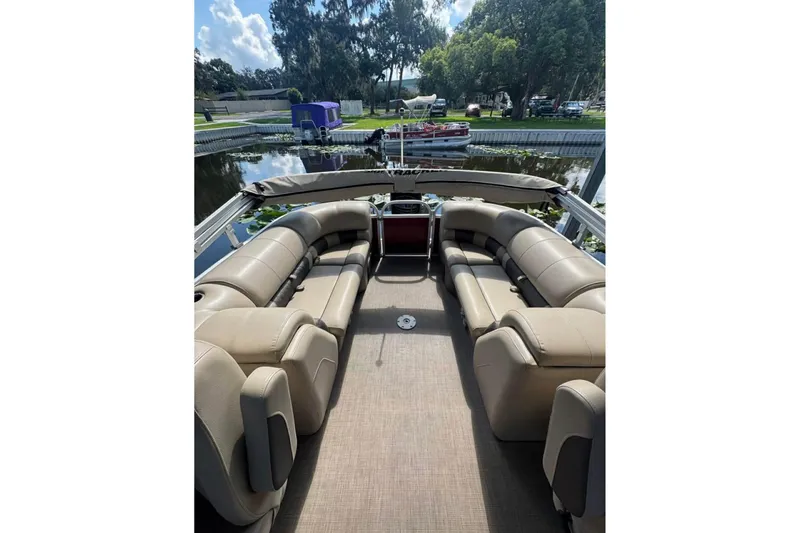 Slide: The Image of 2023 Sun Tracker Party Barge 24 DLX with spacious seating on a calm lake. - 6