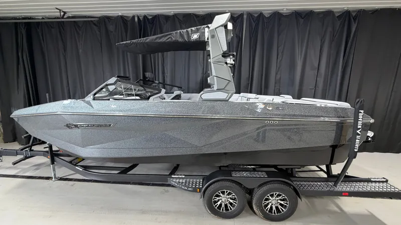 Slide: The Image of A modern motorboat on a trailer inside a garage. - 0