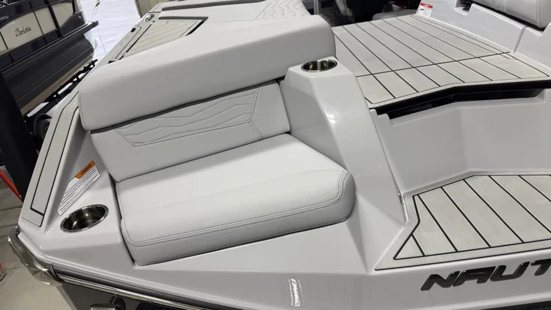 Slide: The Image of A modern boat with gray upholstery and cup holders on the deck. - 12