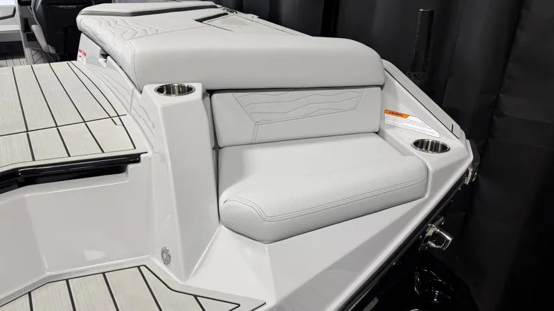 Slide: The Image of The image shows the rear of a boat with gray upholstery and cup holders. - 14