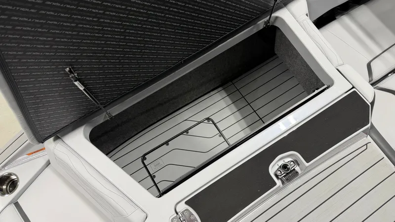 Slide: The Image of An open storage compartment on a boat with a cushioned lid and metal frame. - 16