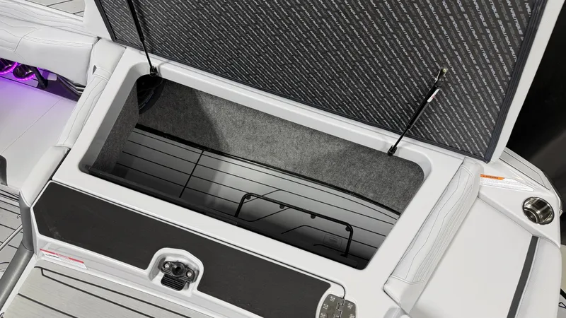 Slide: The Image of An open storage compartment on a modern boat with cushioned seats and LED lighting. - 18