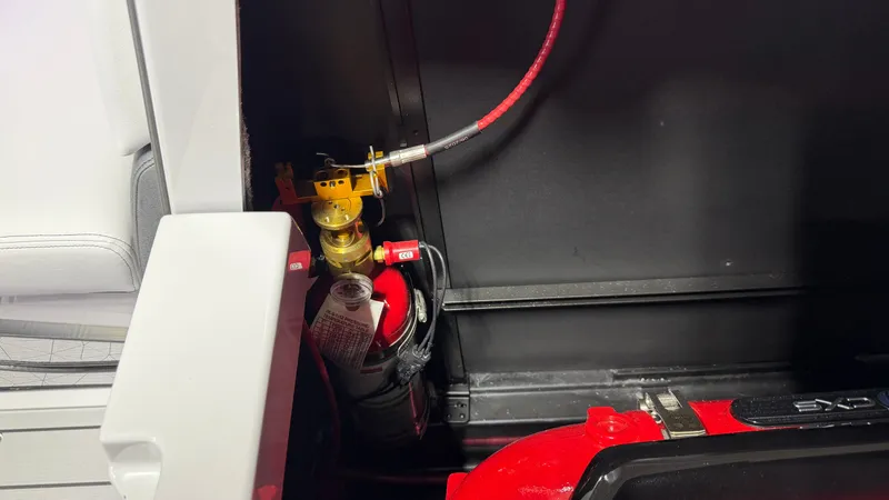 Slide: The Image of A fire extinguisher is installed in a boat, surrounded by black and white surfaces. - 22