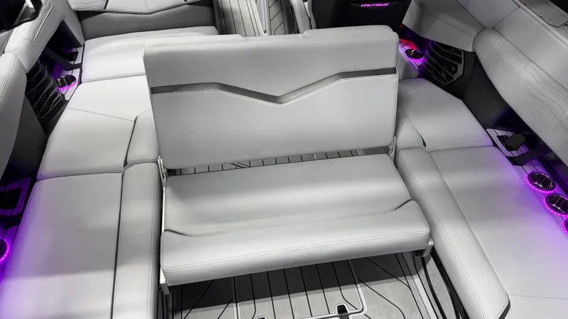 Slide: The Image of Interior of a modern boat with gray seating and purple lighting. - 25