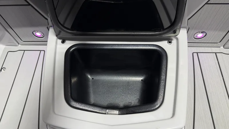 Slide: The Image of An open storage compartment on a boat with purple lighting. - 27