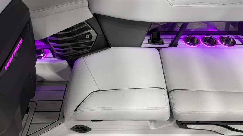 Slide: The Image of Interior of a boat with white seats and purple lighting. - 29