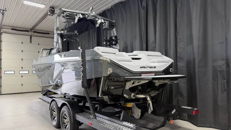 Slide: The Image of A modern Nautique Super Air Nautique G23 on a trailer inside a garage. - 3