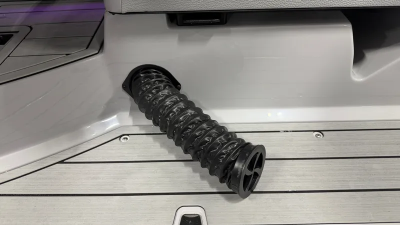 Slide: The Image of A black, flexible hose on a gray boat floor. - 32
