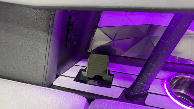 Slide: The Image of Interior of a boat with purple lighting and a cup holder. - 36