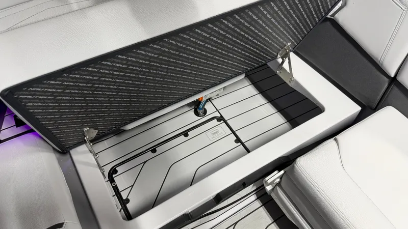 Slide: The Image of An open storage compartment on a boat with cushioned seating. - 39