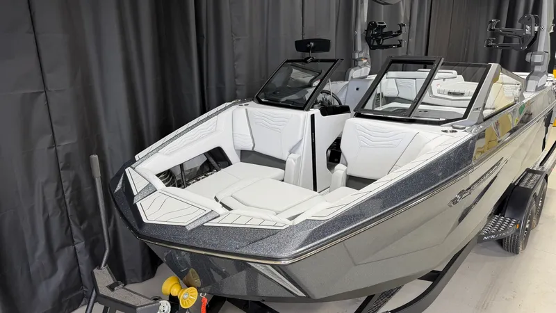 Slide: The Image of A modern boat with white seats and black frame in an indoor setting. - 4
