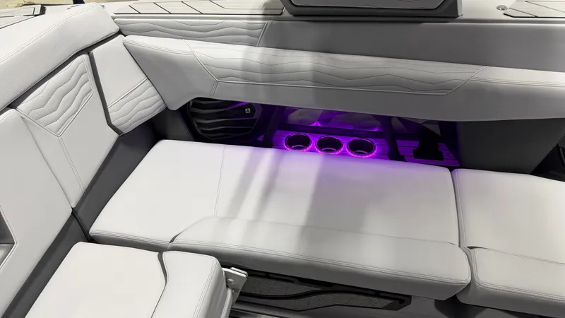 Slide: The Image of Interior of a boat with white upholstery and purple lighting. - 40