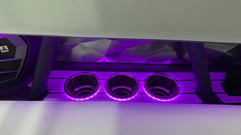 Slide: The Image of Three illuminated cup holders with purple lighting on a boat. - 43