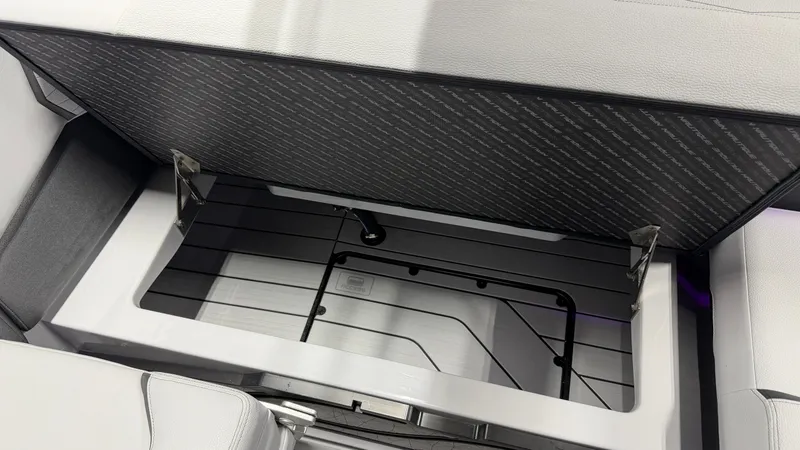 Slide: The Image of An open storage compartment on a boat with a cushioned lid. - 45