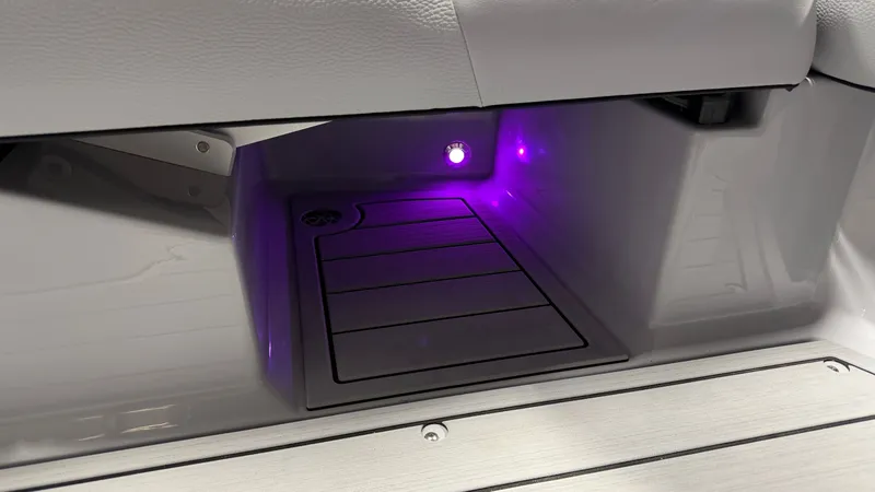 Slide: The Image of A lit storage compartment with purple light inside a boat. - 47